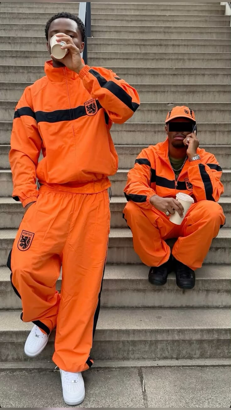Orange tracksuits on concrete steps